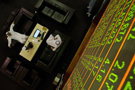 Image: Emarati men follow the latest developments at the Dubai Financial Market