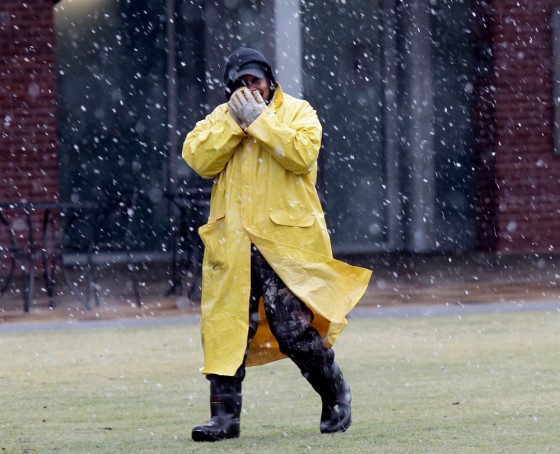 Image: Geraldo Mata keeps warm while walking outside in the snow