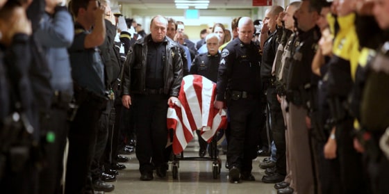 Image: Officers pay respects to fellow officer Kent Mundell