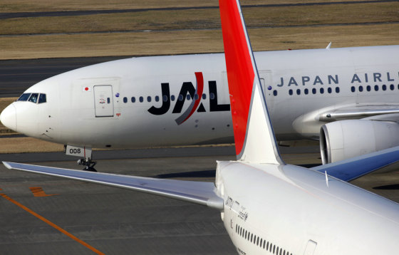 Image: A Japan Airlines jet taxies past another JAL plane