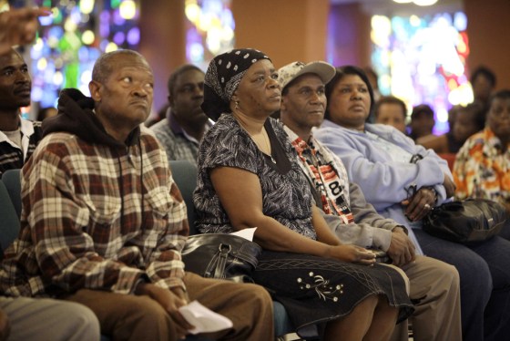 Image: Several hundred Haitians in Miami listen to a lawyer