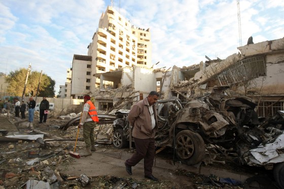 Image: Clearing debris a day after a bomb blast in Jadriyah, south of Baghdad