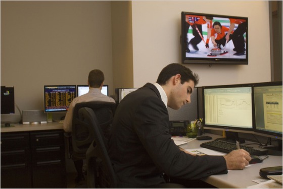 Marc Lombardo, an analyst at Meredith Whitney Advisory Group, keeps Olympic curling on television while working.