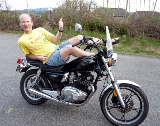 Bellingham Christian School Principal Bob Sampson lounges on his motorcycle at his home on Tuesday. Sampson canceled classes at the private school on Wednesday for a "sun day.”