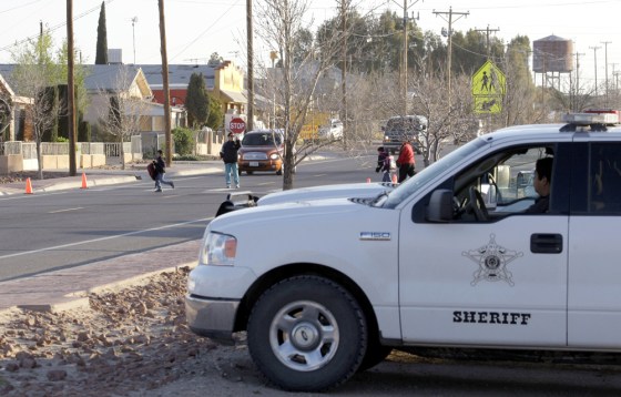 Image: deputy sheriff sits watch as school children cross the street