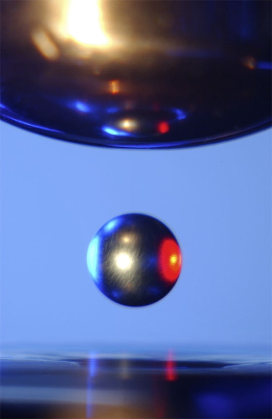 Inside a NASA Electrostatic Levitator, a ball of metal is suspended in mid-air by static electricity.