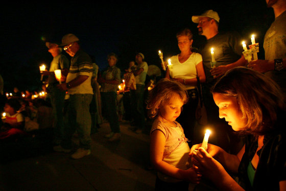 Image: A candlelight vigil for six local coal miners still trapped 1,500 feet beneath the surface at the Crandall Canyon Mine in August 2007.