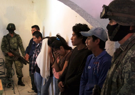 Image: Members of a gang believed to be involved in drug related crimes are presented to the media following their arrest in Cuernavaca