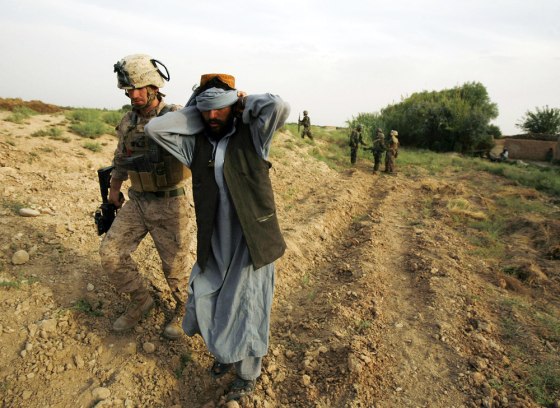 Image: U.S. Marine takes an Afghani civilian to the main Marine base for questioning in Karez-e-Sayyidi