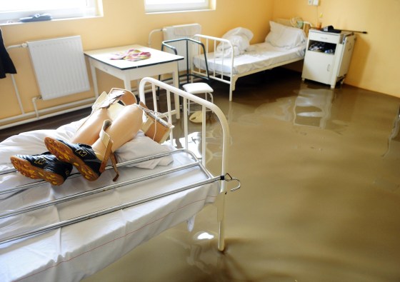 Image: Prosthetic legs lie on a bed in a hospital that was evacuated in Szikszo