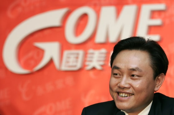 Image: File photo of Gome founder Huang smiling during a news conference in Beijing