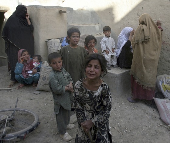Image: Afghan children are terrified after they hear the blast of a controlled explosion near their house in Ghazni province south of Kabul