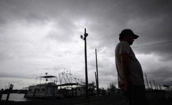 Image: A Vietnamese oyster fisherman stands idle at the docks in Empire, La.