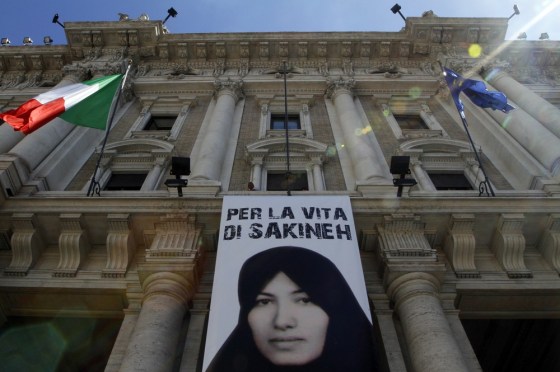 Image: A banner in support of Sakineh Mohammadi Ashtiani is hung outside the Equal Opportunities Ministry palace in Rome
