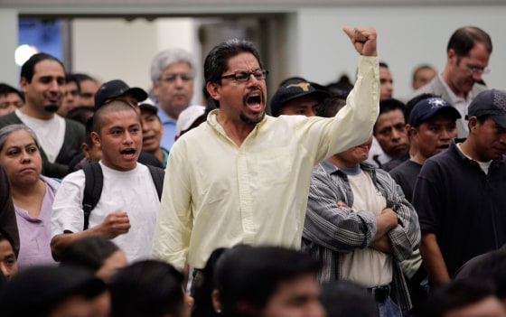 Image: A man yells as he listens to Los Angeles police Chief Charlie Beck during a community meeting in Los Angeles