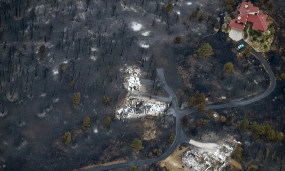 Image: An aerial view shows a seemingly untouched home next to two other homes that were destroyed by the Fourmile Canyon fire in Boulder, Colorado