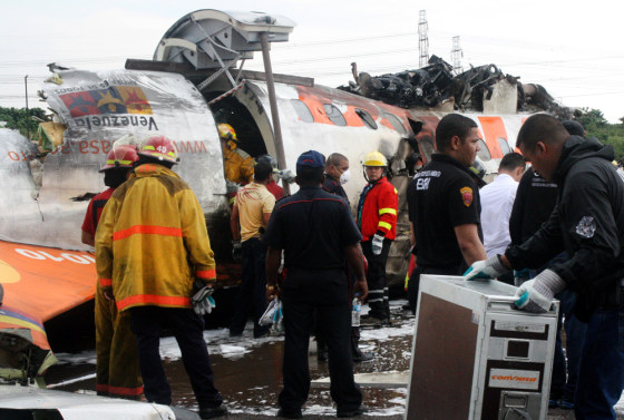 Image: Rescue workers search for victims at the place where a ATR-42 plane crashed in Puerto Ordaz