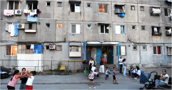 Roma children play in front of a building in the Bucharest Roma suburb of Ferentari. 