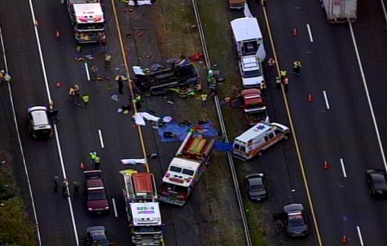 Rescuers respond Saturday to a accident that killed at least six people when a church minivan collided with a tractor-trailer on the New York StattThruway in Woodbury, N.Y.