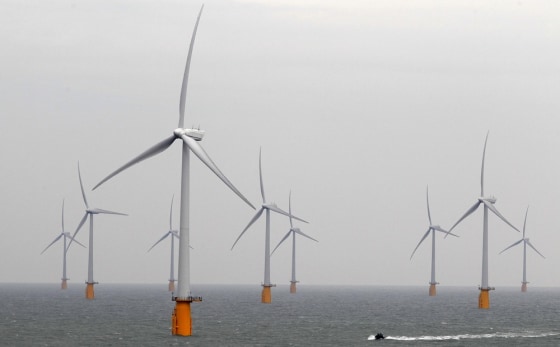 Image: A boat powers past the Thanet Offshore Wind Farm off the Kent coast in southern England