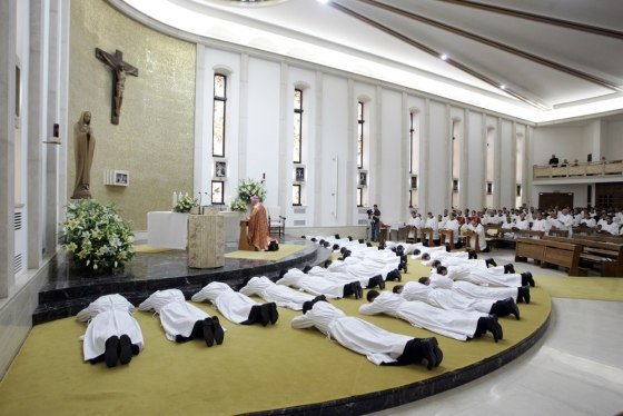 Image: New deacons prostrate in front of the altar during their ordination mass at the Legionaries of Christ center