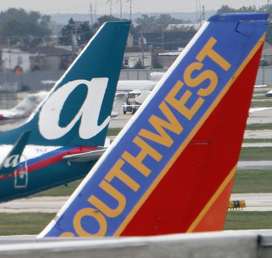 Image: AirTran and Southwest Airlines jets sit on the tarmack at Midway International airport in Chicago