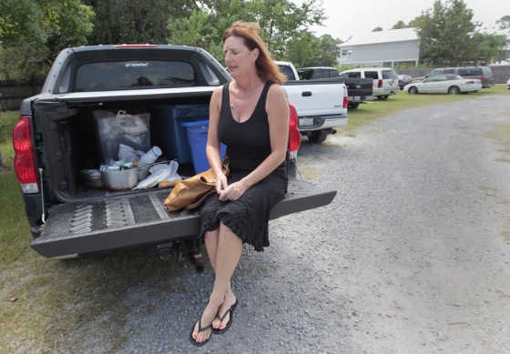 Image: Margaret Carruth sits on the tailgate of her pickup truck