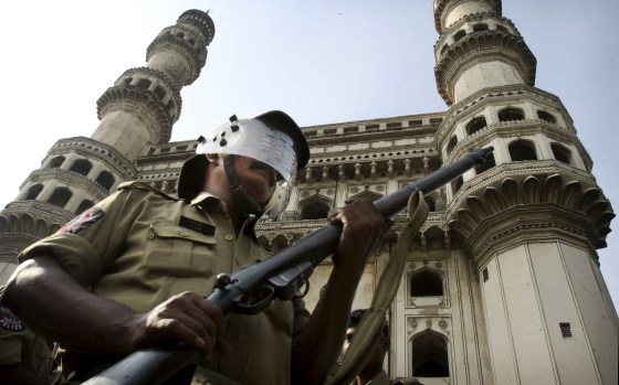Image: An Indian policeman stands guard in front of the landmark Charminar in Hyderabad, India.