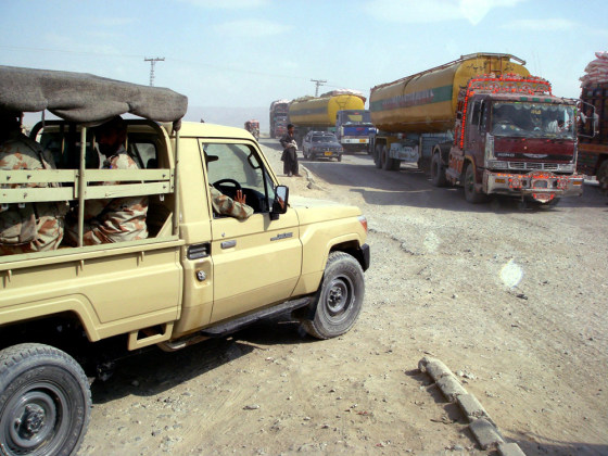Image: Pakistani soldiers and NATO supply trucks