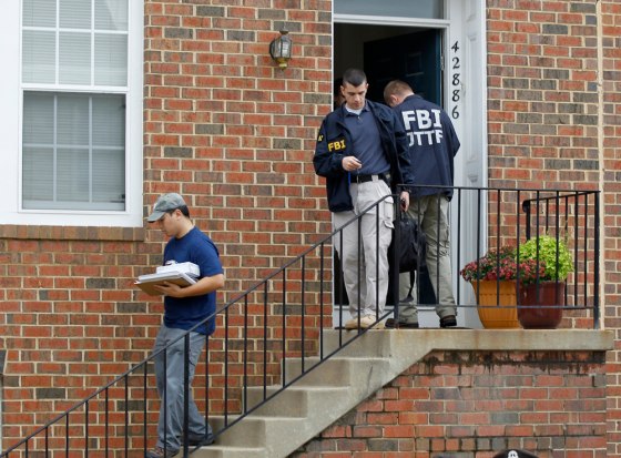 Image: FBI Investigators leave the home of Farooque Ahmed in Ashburn, Va.