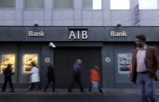 Image: eople walk past a branch of the AIB bank on Merrion Row in Central Dublin