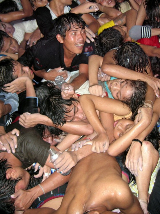 Image: People reach for help near a bridge in Phnom Penh