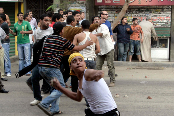 Image: Egyptian Christians throw stones against police during a riot
