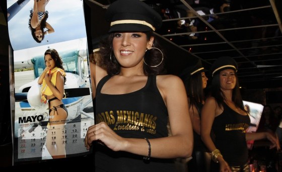 Image: Stewardesses pose with calendar