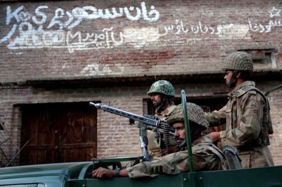 Pakistani soldiers patrol the village of Shamay, June 14, 2009, on the front line in the Sakhra Valley, a small valley within the Swat Valley.