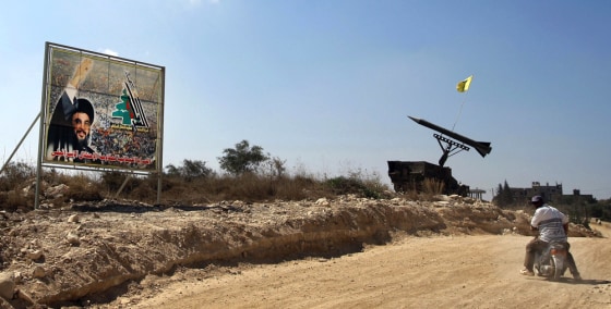 A Lebanese drives his motorcycle past a