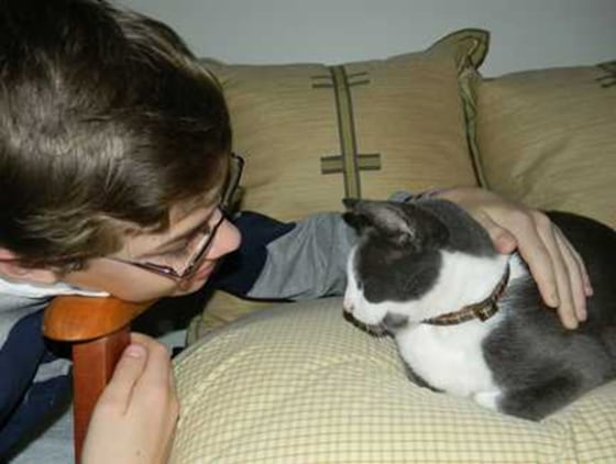 Scrub, a cat that went missing for five years in the aftermath of Hurricane Katrina, is petted by one of his owners, Matthew Noble. The feline was reunited after the Humane Society of South Mississippi identified him via a microchip.