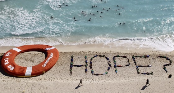 Image: Activists of Environment Greenpeace perform next to a giant life ring, during talks on climate change, in Cancun beach