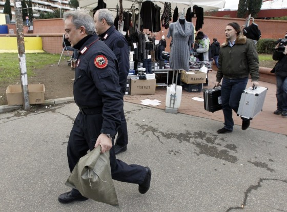 Image: Carabinieri carry equipments outside the underground train station where an explosive device was found, in Rome