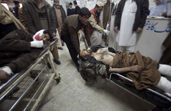 Image: Men injured in a suicide bomb attack in Pakistan's northwest Bajaur region are brought to Lady Reading Hospital in Peshawar for treatment