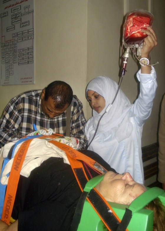 Image: An unidentified injured tour bus passenger is treated at an Aswan hospital
