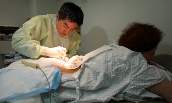 Dr. Roger Lo removing a tumor that he hopes will help researchers find drugs to treat relapsing cancer patients.