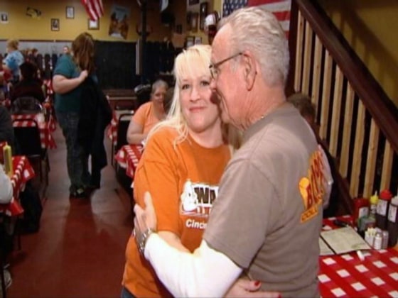 Image: Fred Smith gives waitress Tricia Ayers a hug.