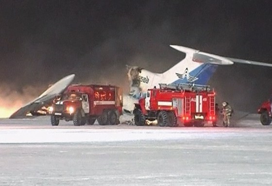 Image: Video grab of fire fighting vehicles parking near a Tupolev-154 passenger plane that caught fire and blew up in Surgut Airport