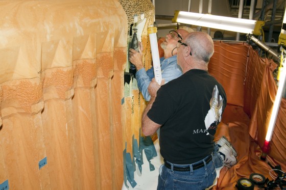 Technicians make repairs to the shuttle Discovery's external fuel tank inside the Vehicle Assembly Building at NASA's Kennedy Space Center in Florida on Wednesday. Support ribs on the tank's intertank region are being reinforced by fitting pieces of metal, called radius blocks, over the ribs' edges where they attach to the thrust panel area. The thrust panel is where the tank meets the two solid rocket boosters. It sees the most stress during the flight into orbit.