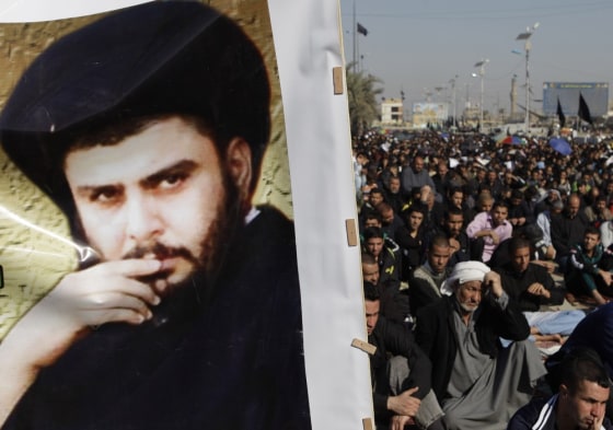 Image: Followers gather for prayers in Sadr City, Baghdad, beside a poster of Shiite cleric Muqtada al-Sadr