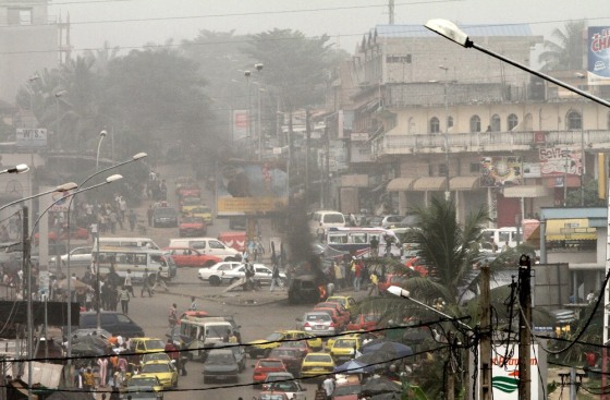 Image: Smoke from burning U.N. vehicle is seen during a protest in Abidjan