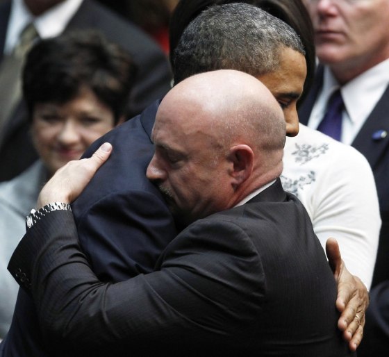 Image: Giffords' husband Kelly hugs U.S. President Obama at \"Together We Thrive: Tucson and America\" event in tucson