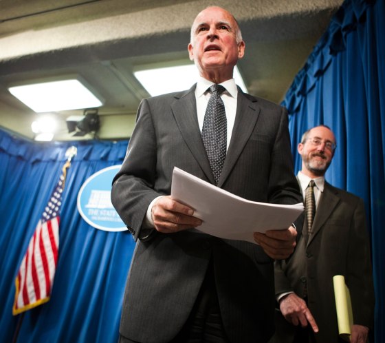 Image: California Governor Jerry Brown leaves a news conference after introducing his budget proposal in Sacramento