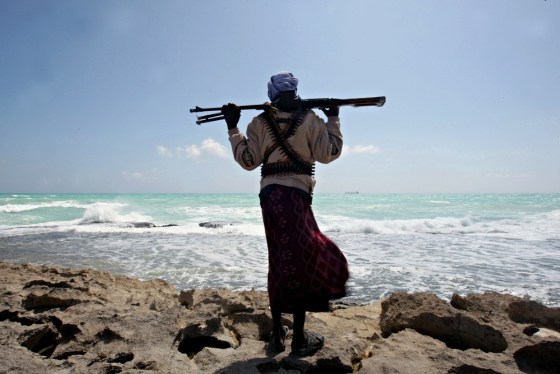 Image: An armed Somali pirate along the coastline